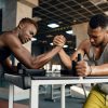 two-men-fighting-arm-wrestling-training-in-gym-CQ468DL-min